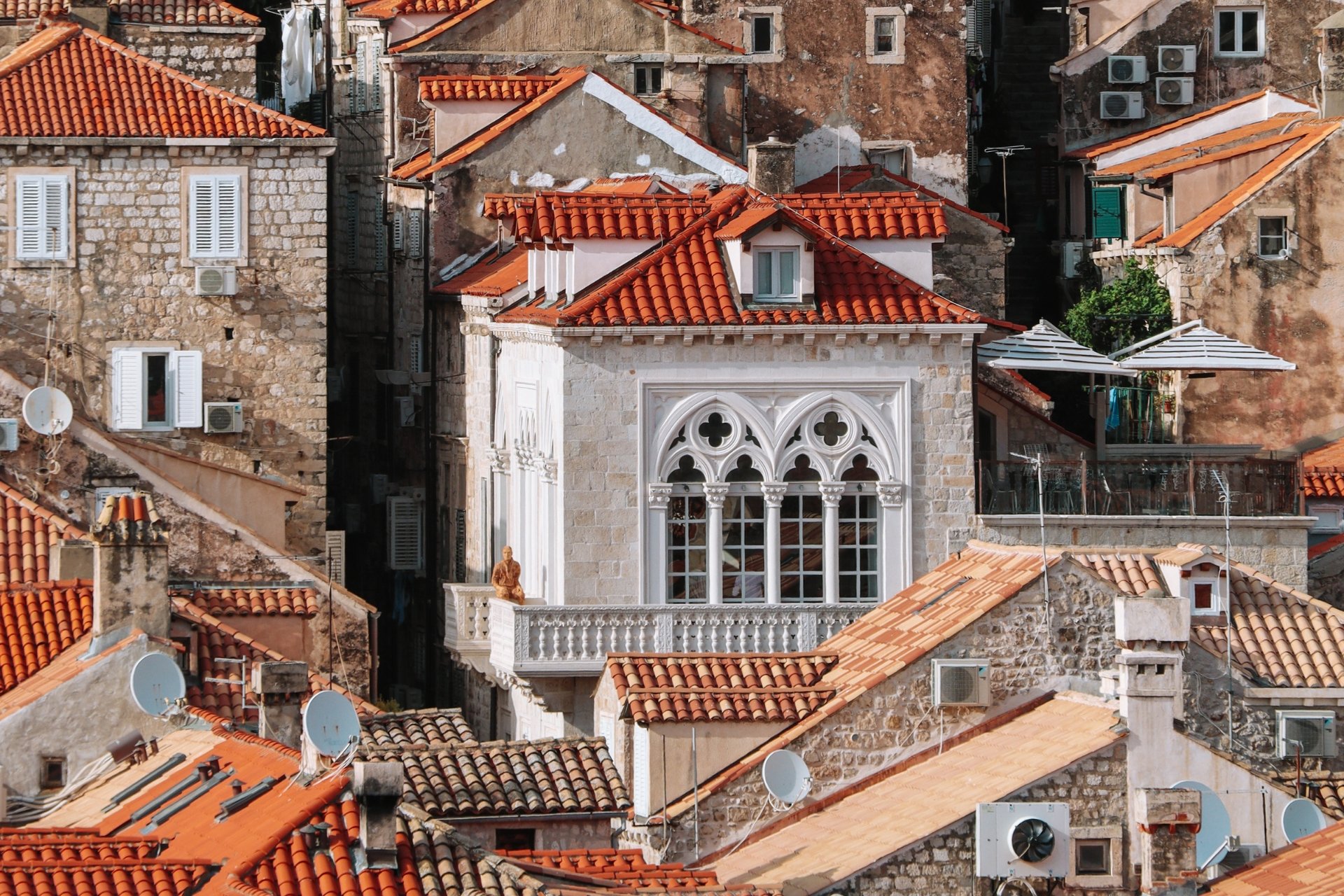 Historic stone houses with terracotta rooftops and Gothic windows in the old town of Dubrovnik during a family travel visit to the Dalmatian coast, Croatia