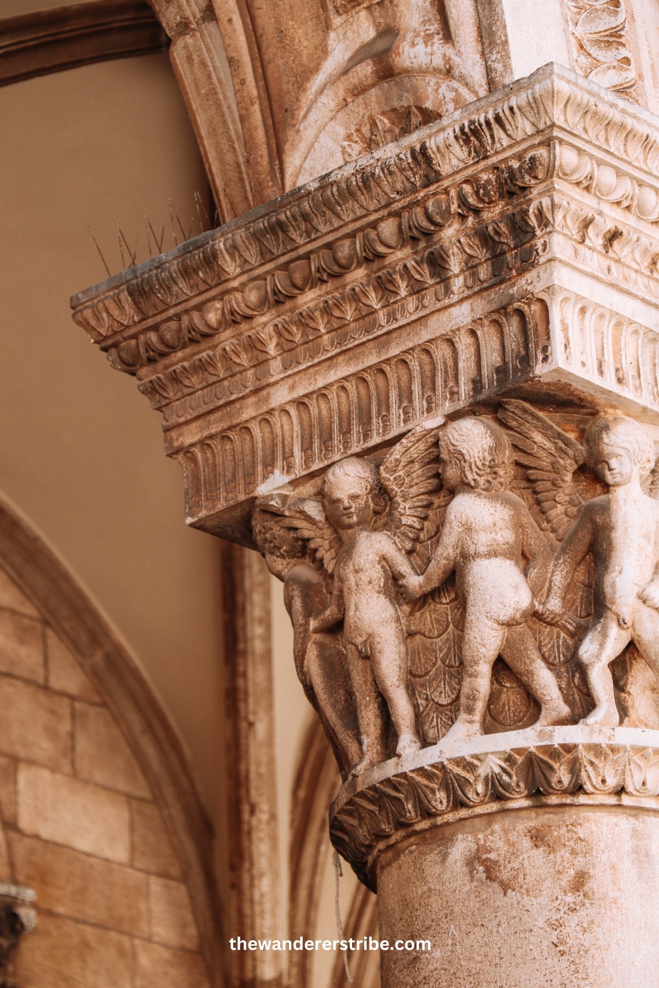 Close-up of a carved stone capital with cherubs in the Rector’s Palace in Dubrovnik