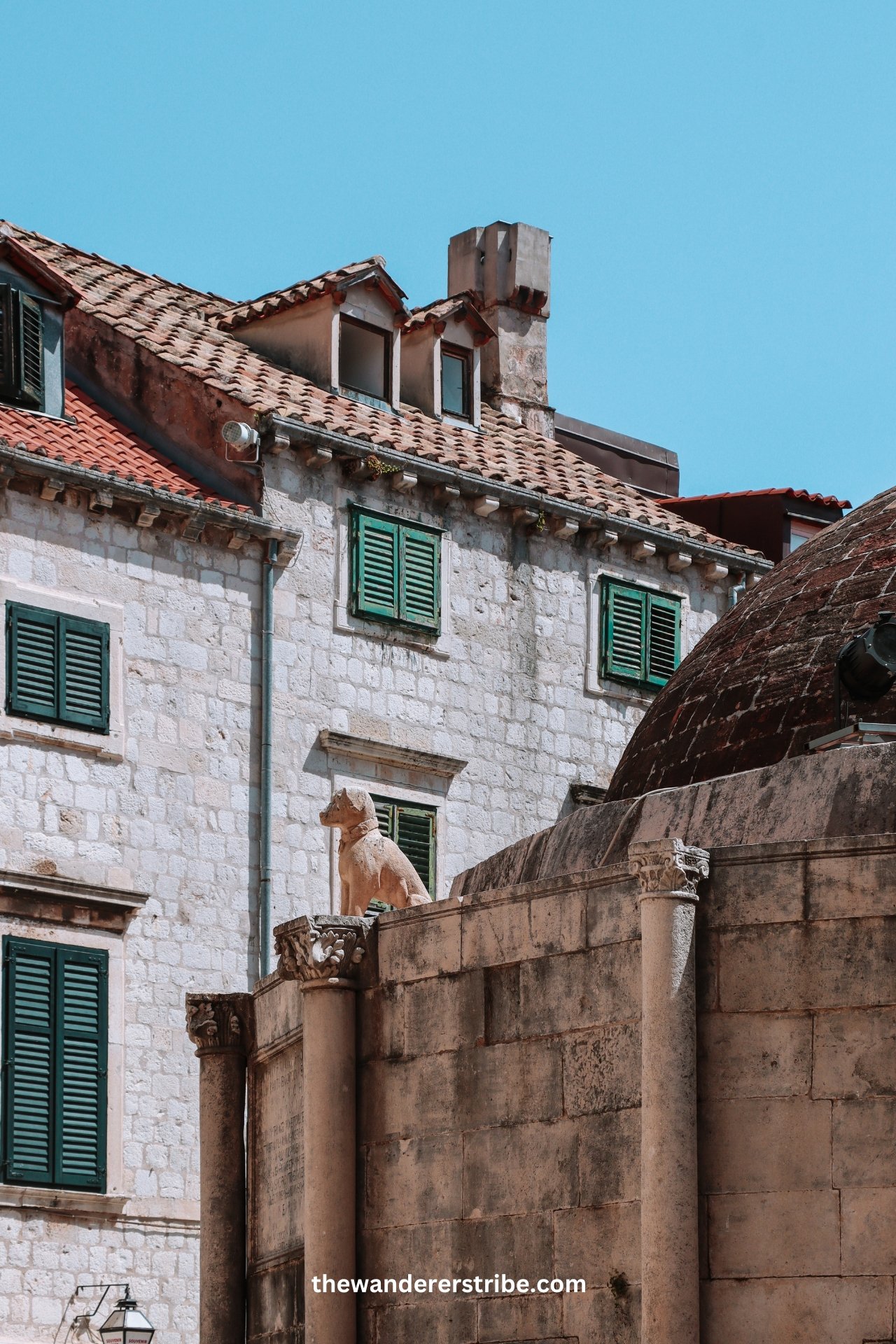 Stone dog statue on top of the Onofrio Fountain in Dubrovnik’s Old Town.